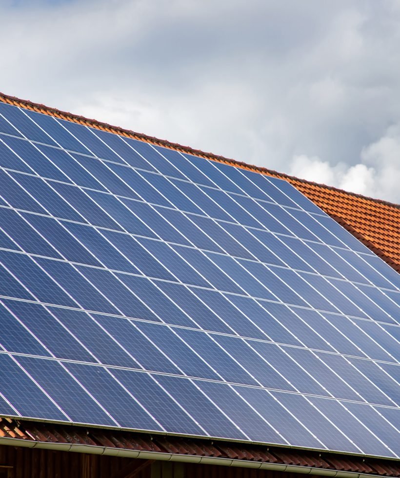 solar panels on the roof of a house. horizontal orientation, blue sky. Energy concept